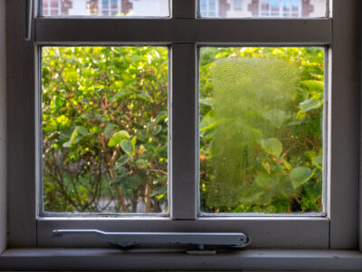 Double glazed window showing condensation droplets between two panes of glass