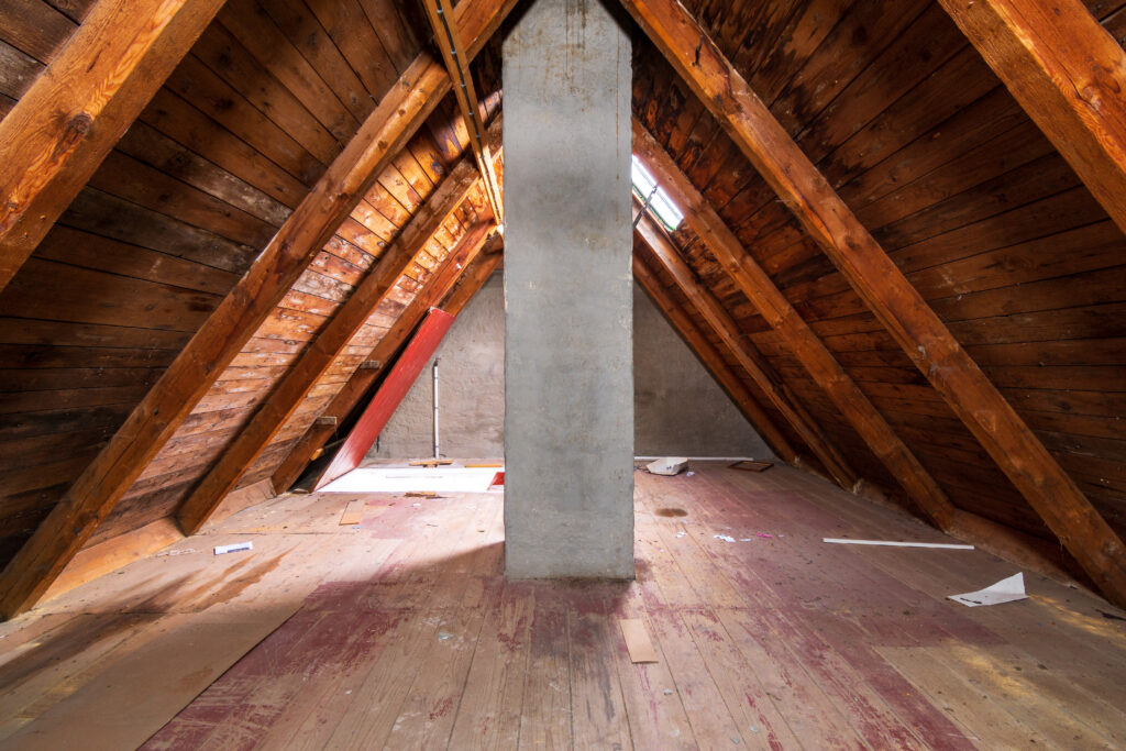 Empty unfinished attic with a chimney