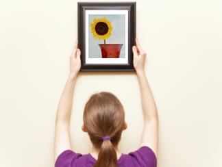 Woman hanging a picture