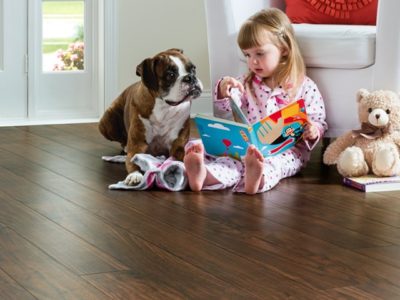 Child and dog sitting on EVP (engineered vinyl plank floor) which is durable and waterproof.