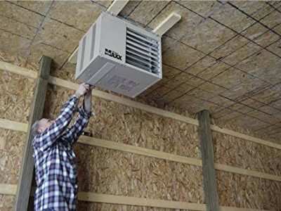 Man installing garage heater