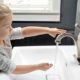 Child using touchless bathroom sink faucet