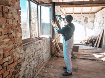 Contractor installing windows