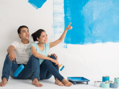 Couple painting an apartment