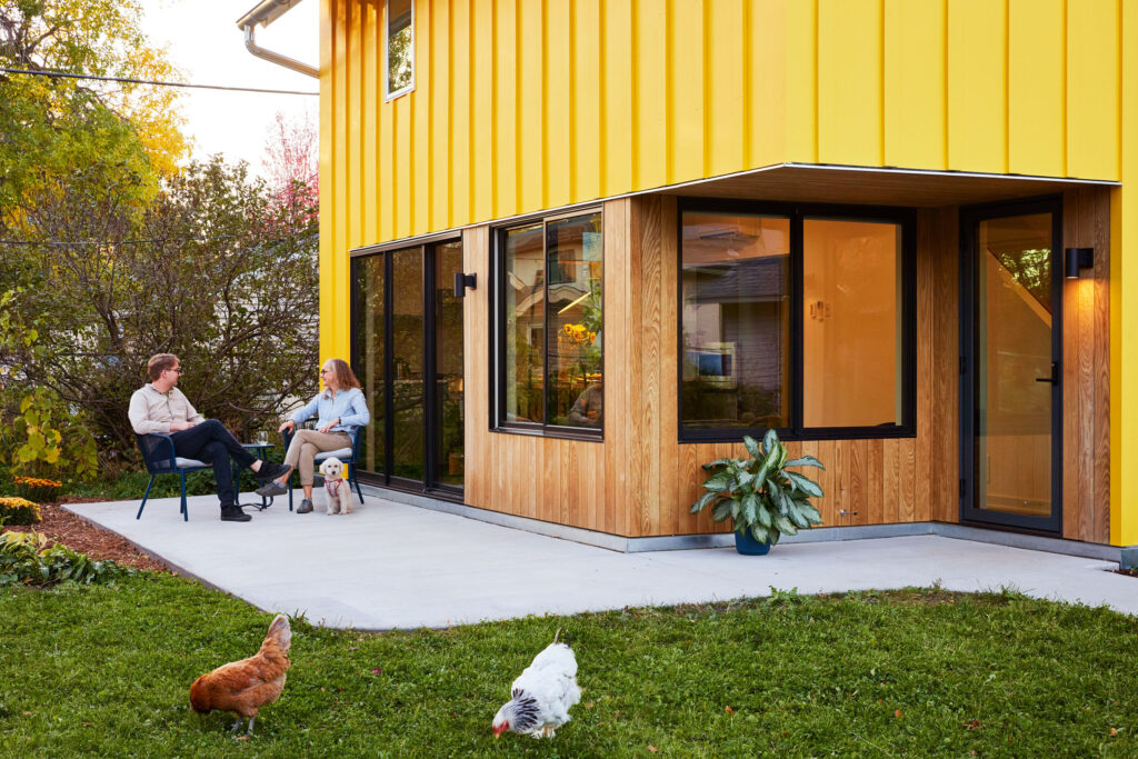 A canary yellow ADU brings a sense of community to a Saint Paul, Minnesota, backyard.