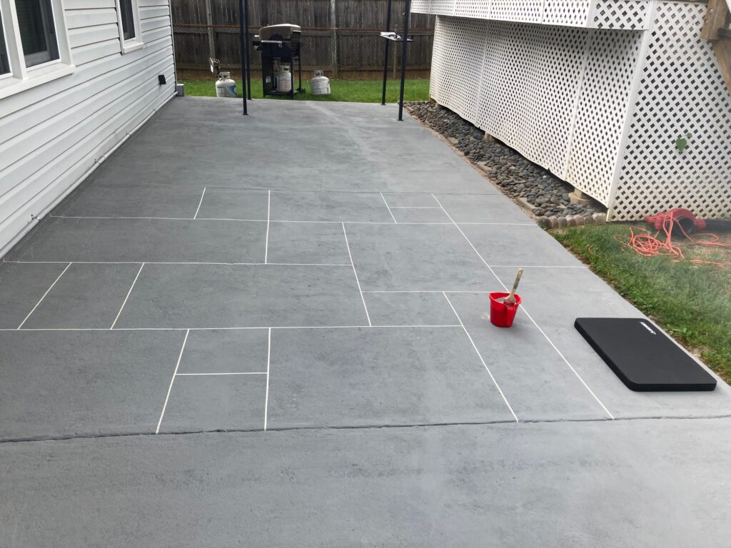 DIYrs Tina and Tim used grout tape to block off different sized rectangles for their SpreadStone™ Decorative Concrete Resurfacer.