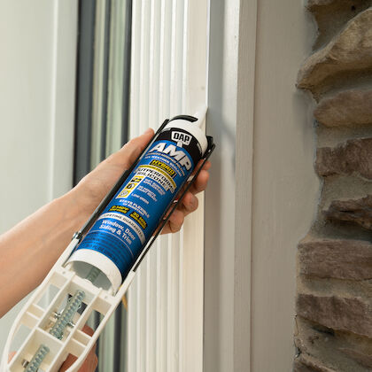 Applying DAP hybrid caulk around a window